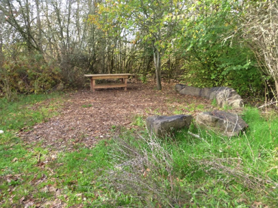 Group gathering area for presentations – table to display items – natural surface – large boulders to sit on